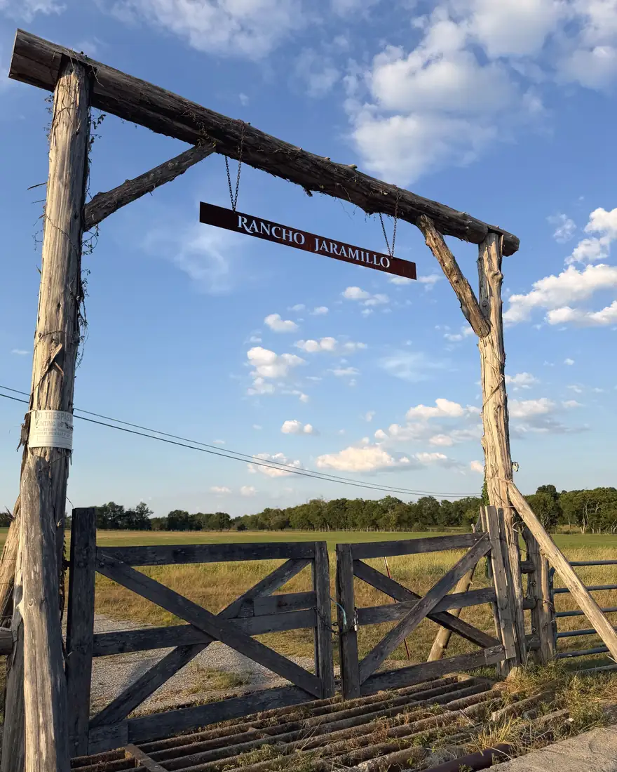 The Rancho Jaramillo gate against an afternoon sky