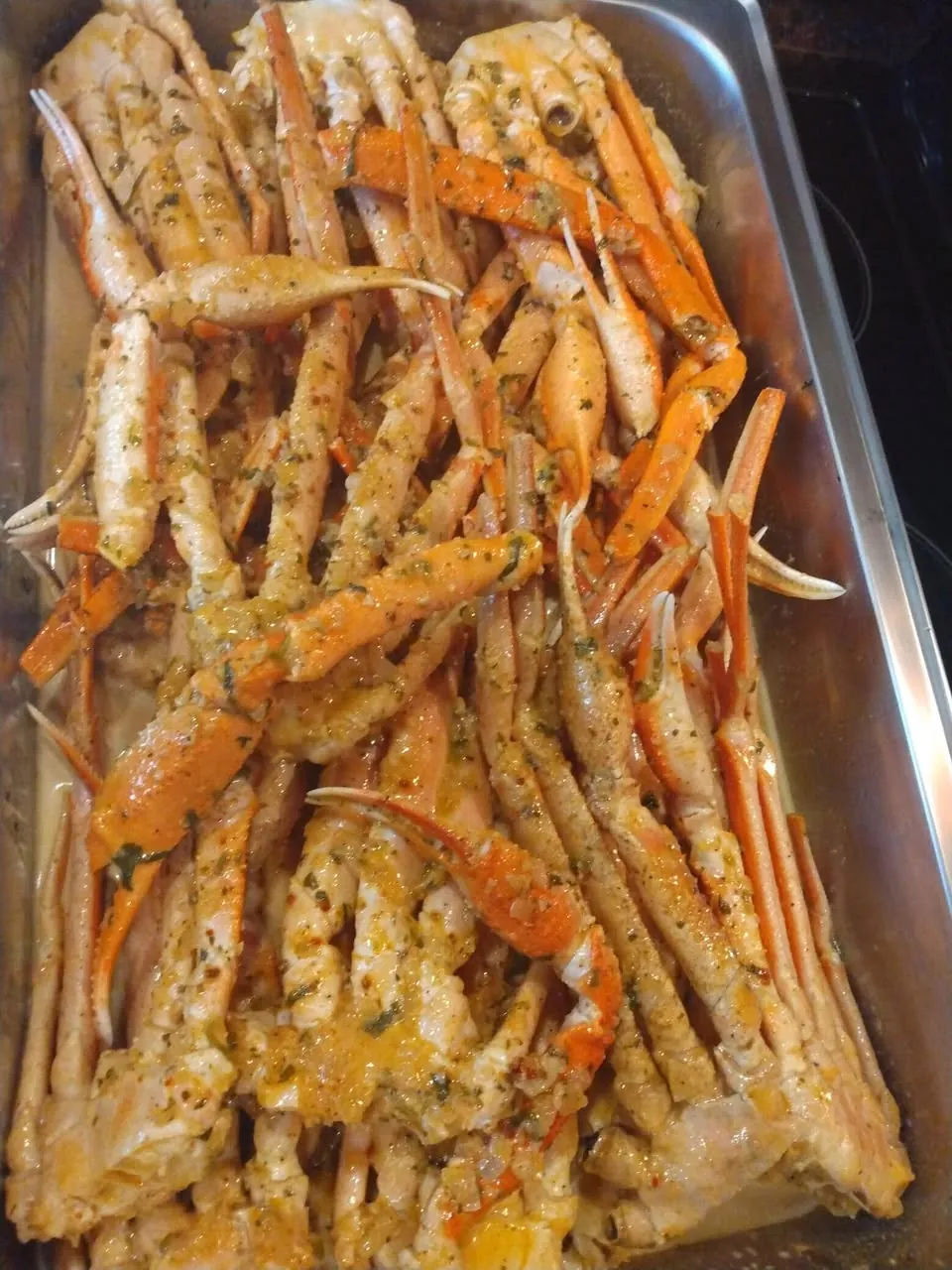 Seasoned snow crab legs in a steel pan
