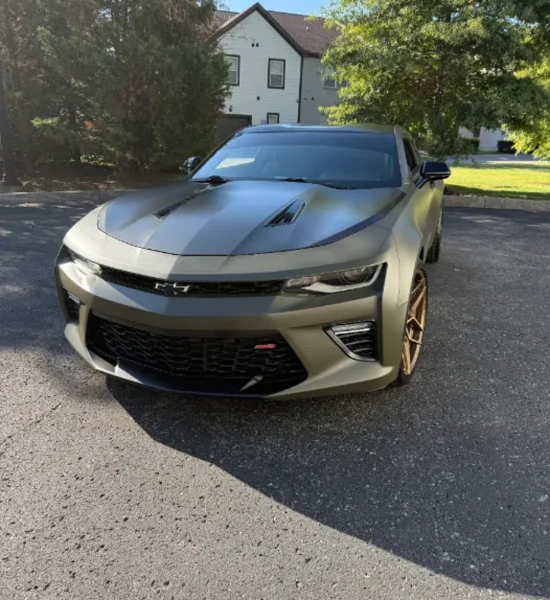 A Chevrolet Camaro SS in satin olive with bronze wheels