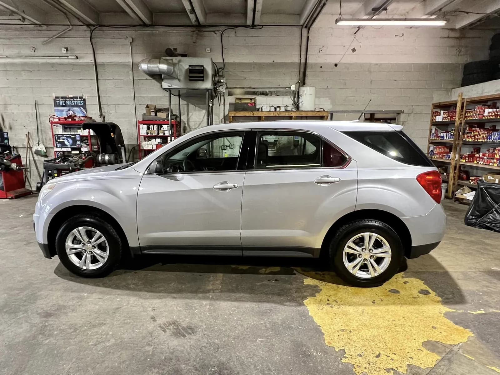 A silver compact SUV parked in a shop bay
