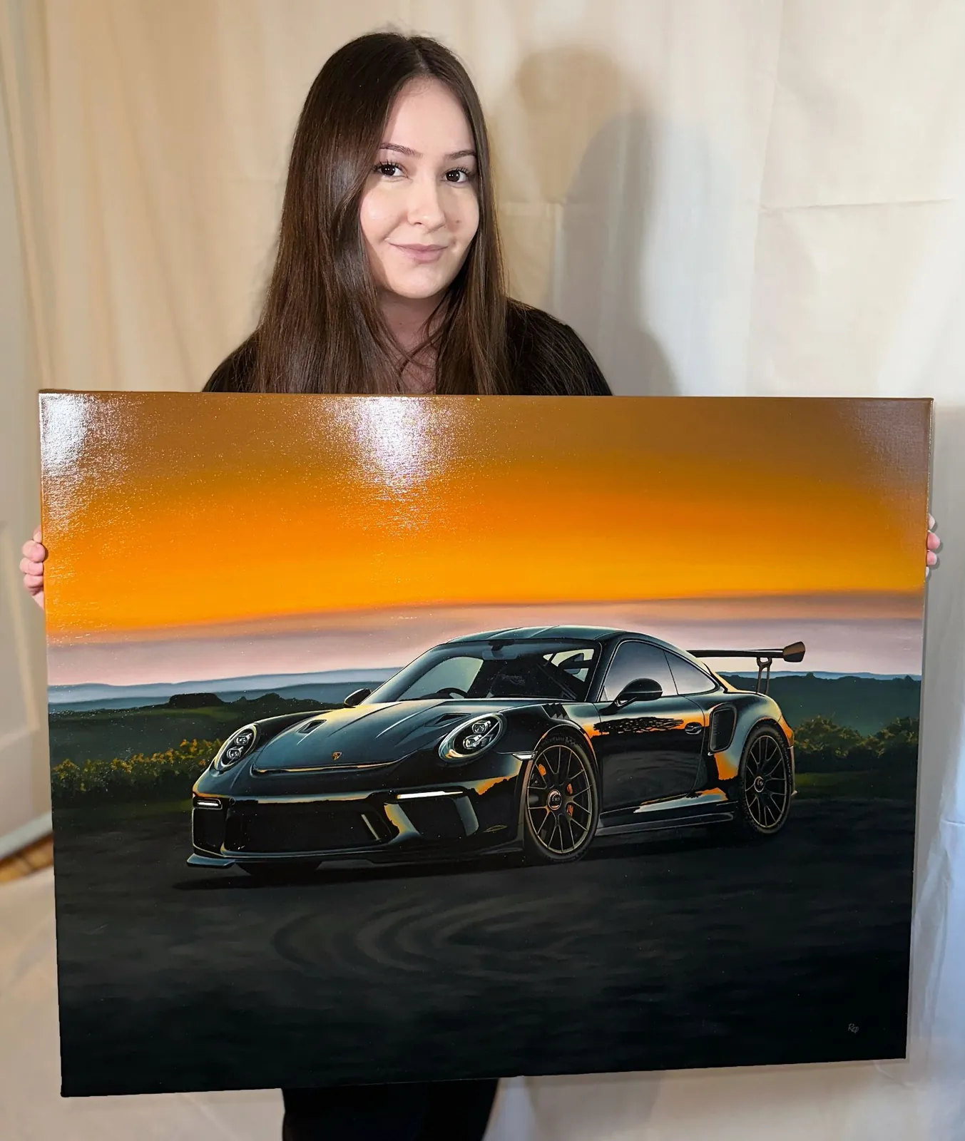 A painting of a black Porsche 911 GT3 RS against an orange sunset