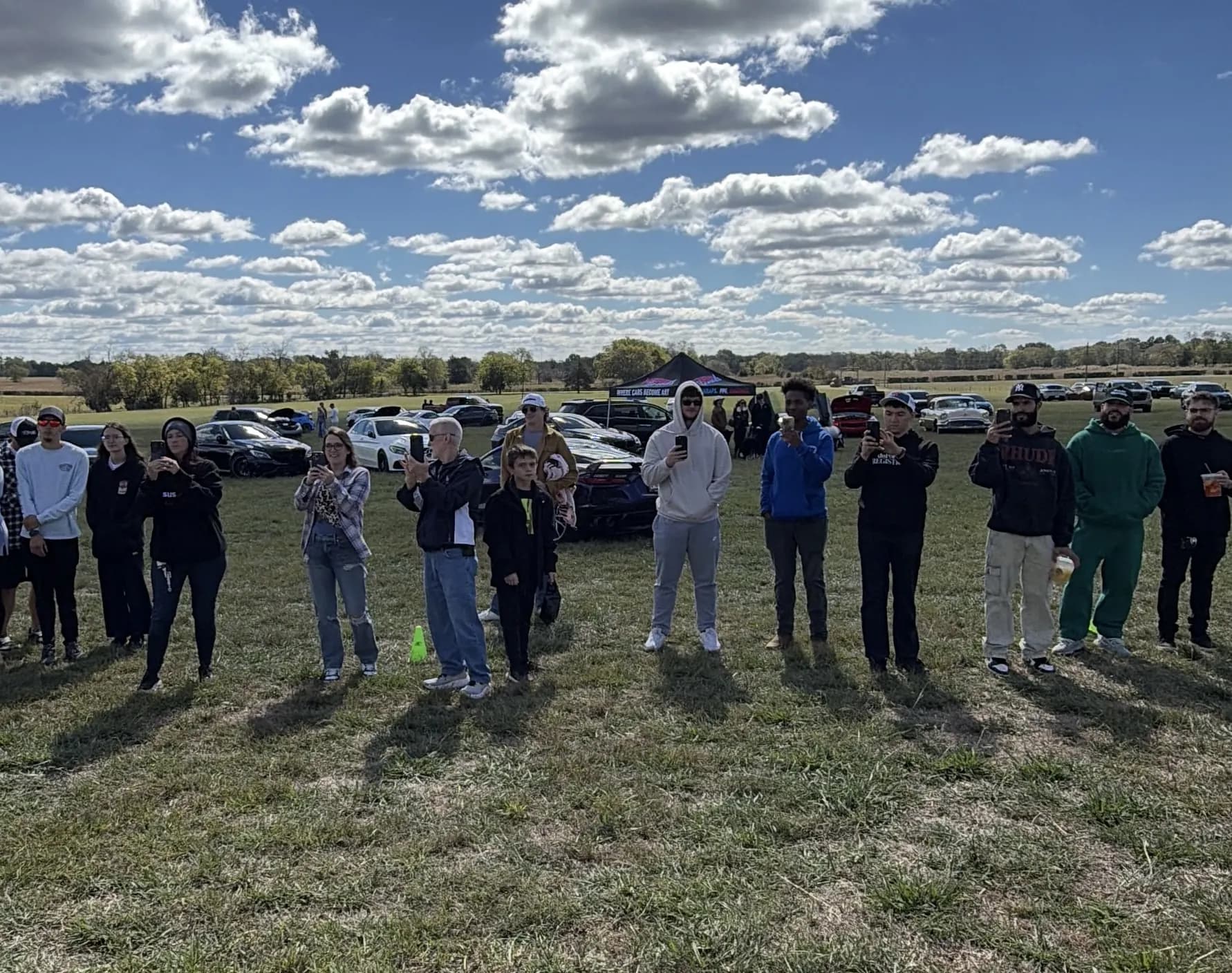 Guests standing together on the show field at Rancho Jaramillo under a big October sky