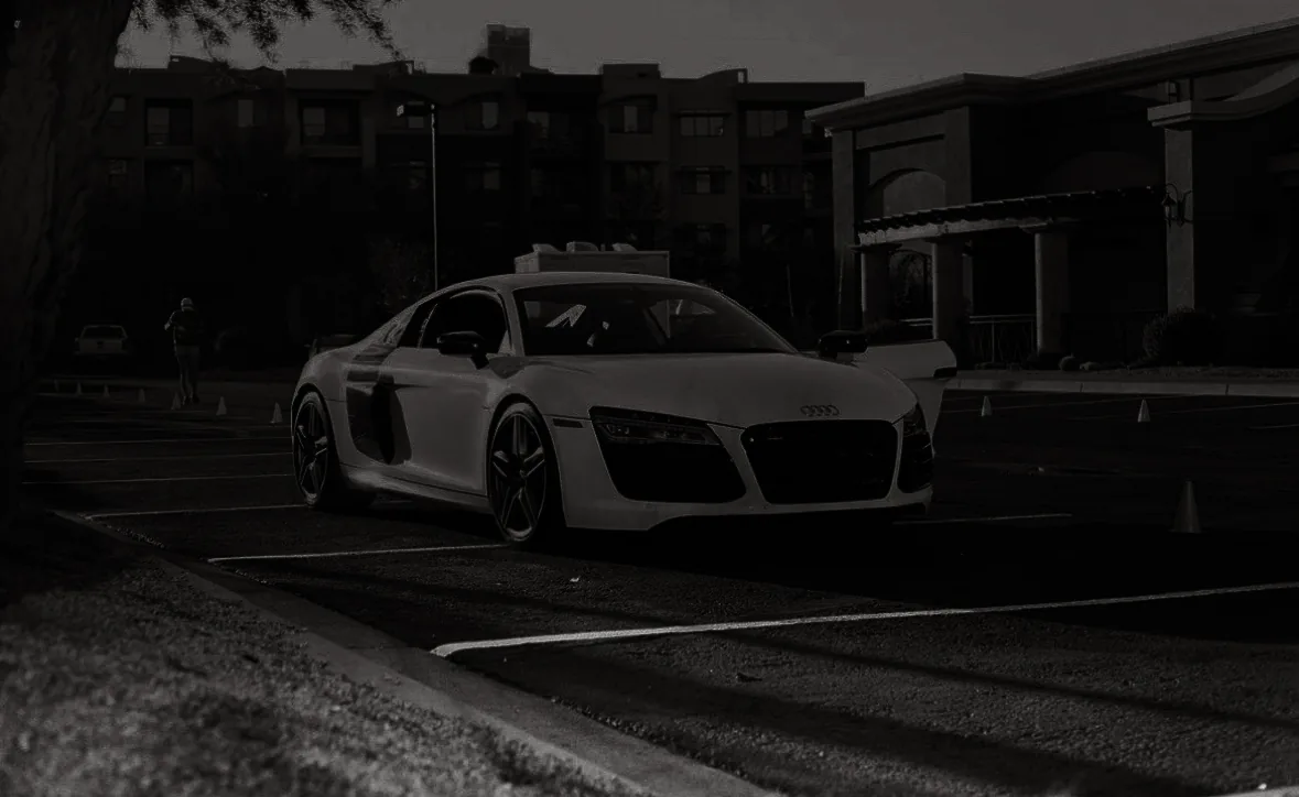 An Audi R8 alone in a car park in the early morning